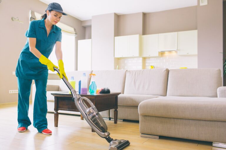 girl-is-walking-studio-apartment-cleaning-floor-with-vacuum-cleaner-she-holds-it-with-both-hands-woman-is-alone (1)